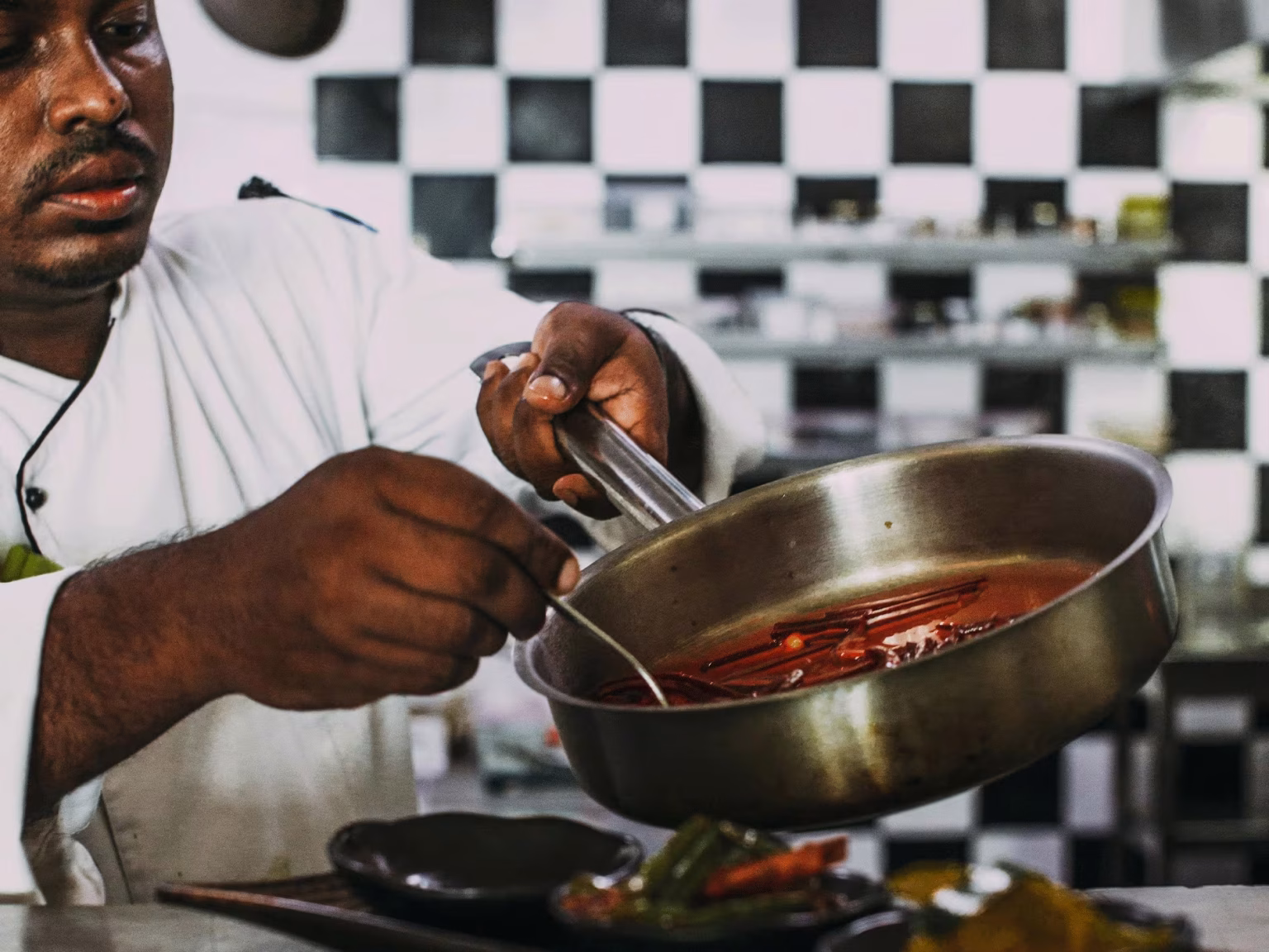 A camp chef cooking a stew