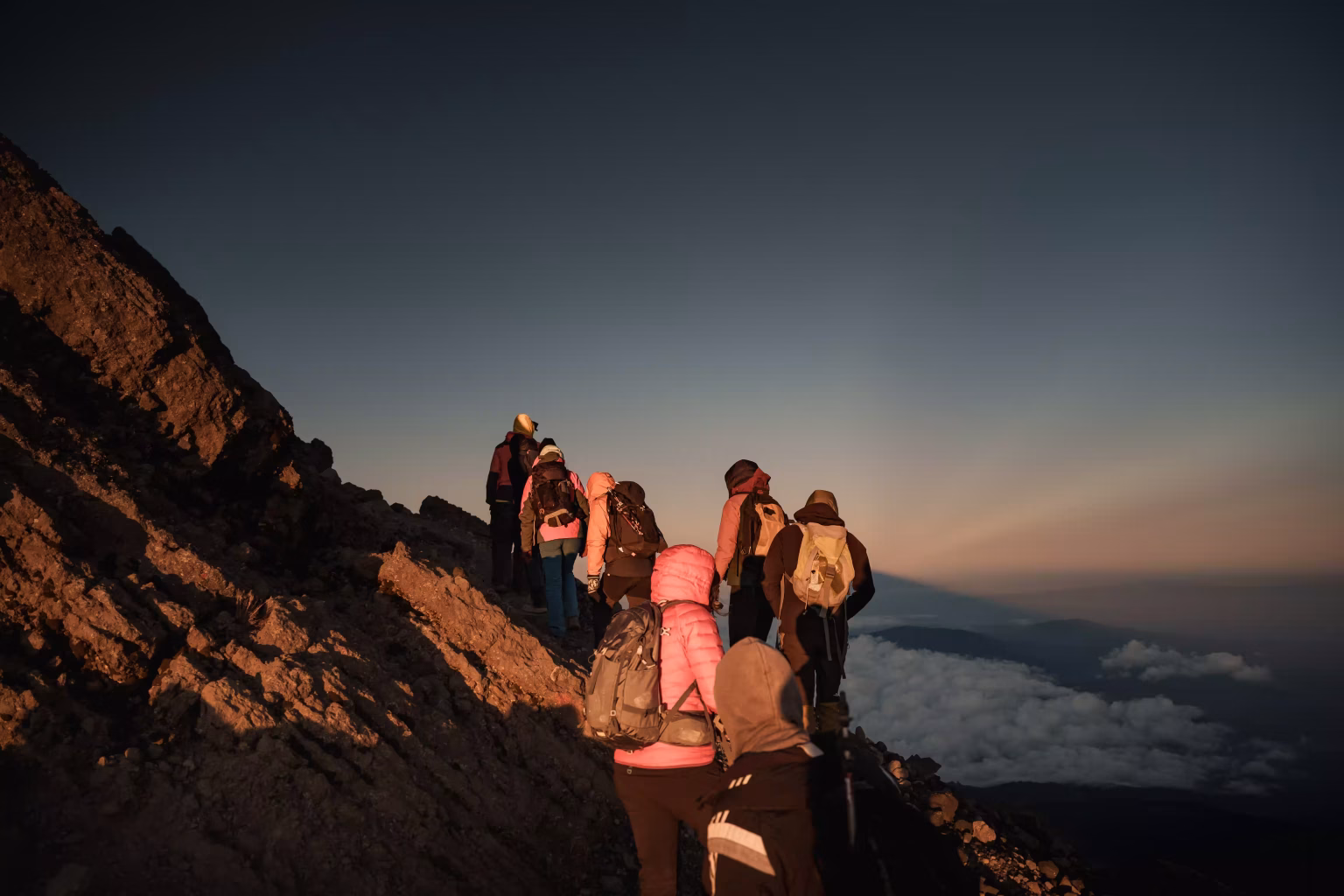 Climbers on a mountain before dawn