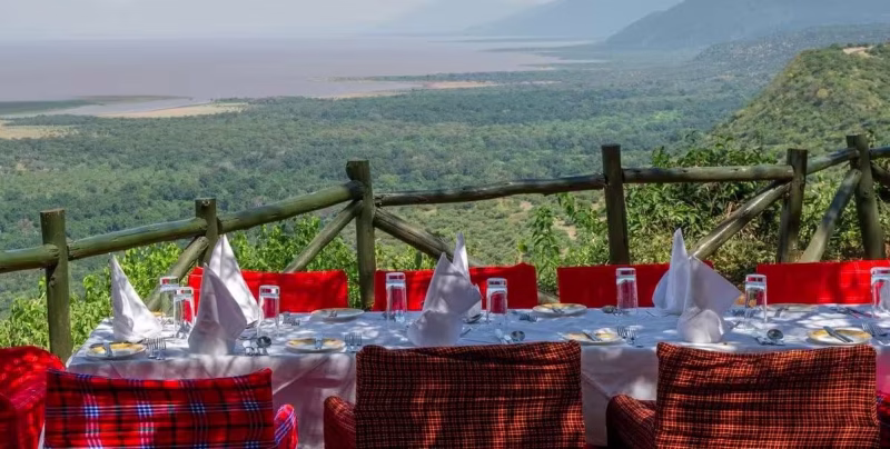 A bush lunch table laid with Maasai cloths above the Great Rift Valley