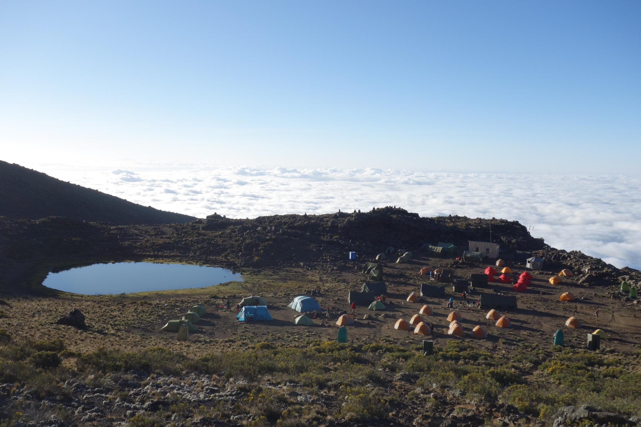 Tents beside Mawenzi Tarn with a sea of cloud beyond