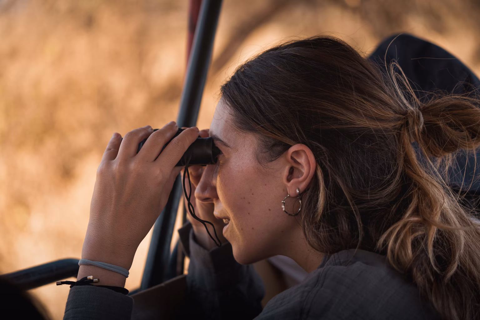 A traveller with binoculars, an item for every Tanzania safari packing list